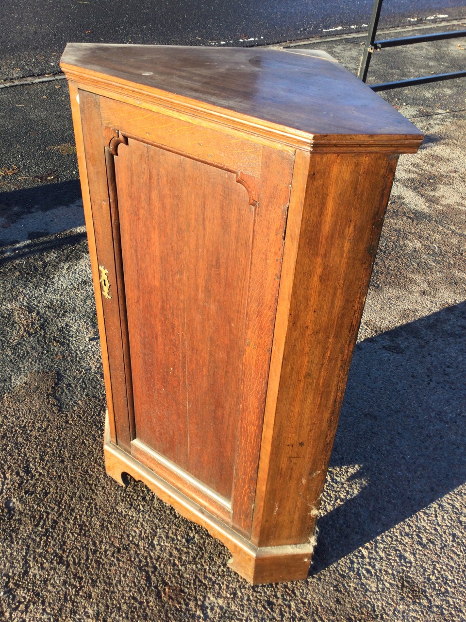 A nineteenth century oak corner cabinet with panelled door enclosing shaped shelves, raised on a - Image 2 of 3