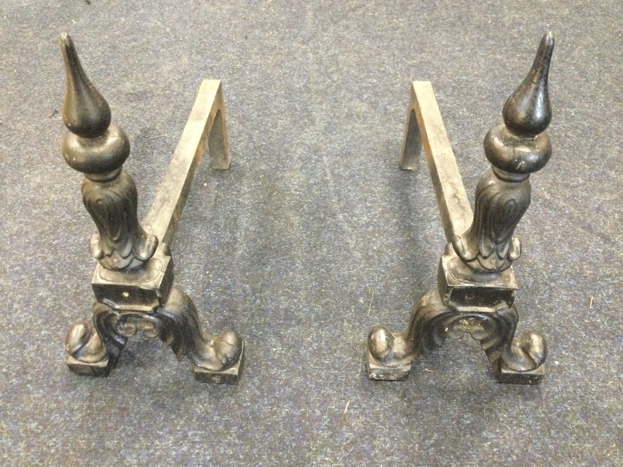 A pair of cast andirons, the columns with pointed finials on leaf scrolled supports, the back - Image 2 of 3