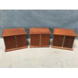 A set of three mahogany coin cabinets with moulded tops & plinths, each having piano hinged doors