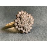 An 18ct gold diamond cluster ring containing 25 brilliant cut stones in lozenge shaped panel, the
