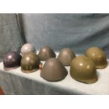 Eight miscellaneous armed forces helmets. (8)