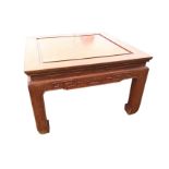 A square Chinese coffee table, with panelled top above aprons having greek key type carved