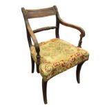 A nineteenth century mahogany elbow chair with ribbed tablet back above a twisted turned joining