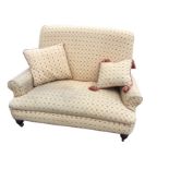 A contemporary two-seater sofa upholstered in gold interlinked tapestry style material, having