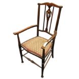 A stained Edwardian armchair with boxwood stringing to shaped back rail above a pierced splat inlaid