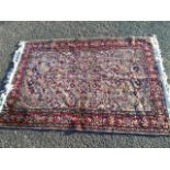 A fine woven silk style rug with multi-floral lilac field framed by frieze of floral medallions on