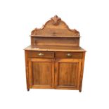 A Victorian carved pine and fruitwood chiffonier with later alterations, the scroll carved arched