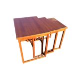 A nest of three teak coffee tables with rectangular tops on square column legs & stretchers. (3)