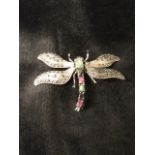 A 925 silver dragonfly brooch, the articulated wings set with marcasites, having claw set rubies,
