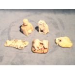 Five carved ivory netsukes, all with signed character marks - a duck, a seated figure with tablet, a
