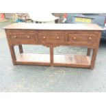 A Georgian style oak potboard dresser with rectangular moulded top above three knobbed frieze