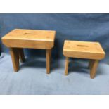 A graduated pair of contemporary craftsman made rectangular oak cracket stools with oval handholes