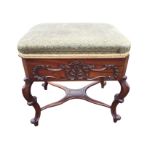A Victorian mahogany piano stool with rectangular cushion box seat having canted corners, above a