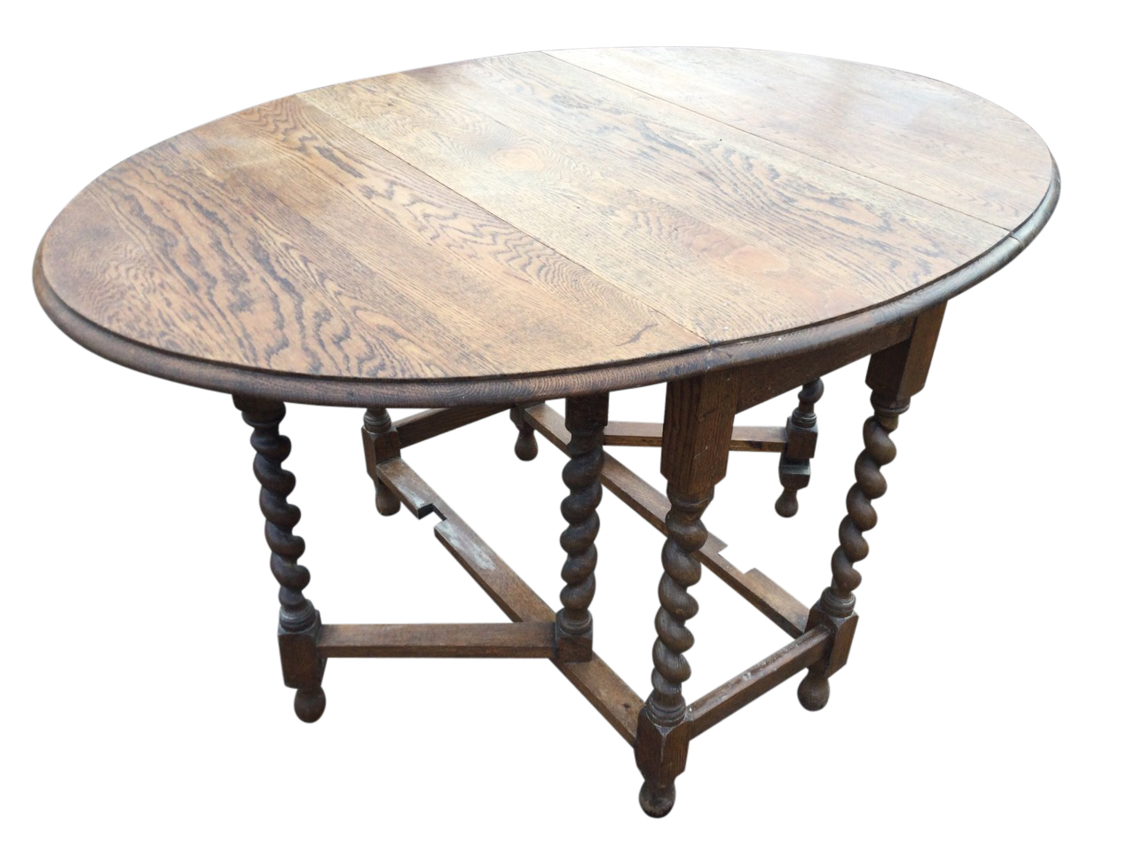 An oval oak gateleg table, the moulded top on barleytwist legs joined by rectangular stretchers,