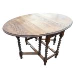 An oval oak gateleg table, the moulded top on barleytwist legs joined by rectangular stretchers,