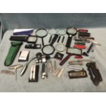 Eleven miscellaneous magnifying glasses; and a quantity of other tools - penknives, bottle