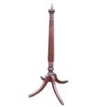 A Victorian 5ft mahogany standard lamp, with fluted tapering column above a leaf carved collar,