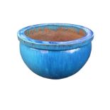 A large blue glazed bulbous stoneware jardiniere with flat moulded rim. (21in)