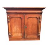 A Victorian ash press cupboard, with angled cornice above a split column frieze, the arched panelled