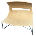 A wacky conservatory seat with curved overhanging canopy pierced with rectangular aperture,