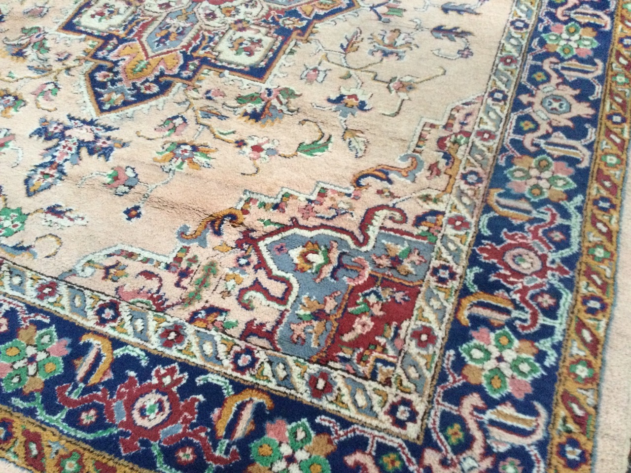 An Axminster wool carpet woven in the eastern Persian manner with central floral medallion on fawn - Image 2 of 3