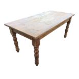 A Victorian style pine kitchen table with rectangular top on turned legs. (63in x 32.25in x 29.5in)