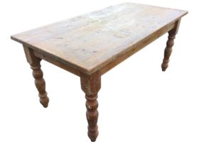 A Victorian style pine kitchen table with rectangular top on turned legs. (63in x 32.25in x 29.5in)