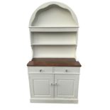 A painted oak dresser with arched delft rack having scalloped apron above a chisel carved frieze