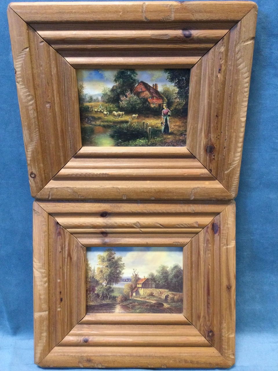 A pair of Victorian style landscape oleographs, one signed indistinctly, in wide moulded pine