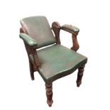 A late Victorian mahogany barbers chair with adjustable back and studded upholstered elbow pad