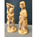 A pair of late Victorian Japanese carved ivory okiniono figures, the lady picking flowers in flowing