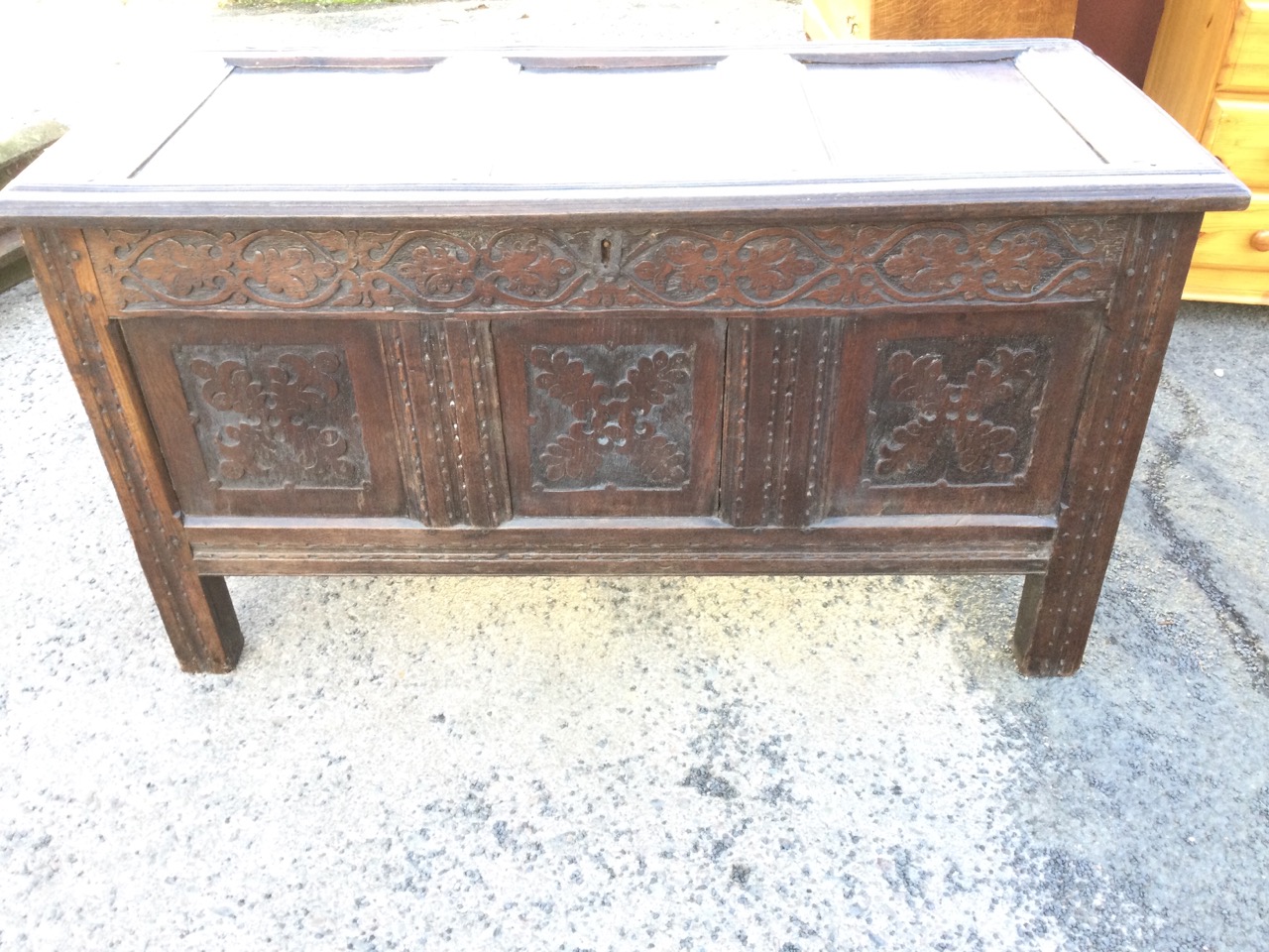 A nineteenth century carved oak coffer with three moulded panels to hinged top, the front with blind - Image 2 of 3