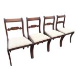 A set of four regency style mahogany dining chairs, with plain backs above joining rails having