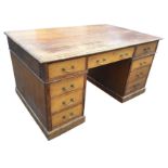 A late Victorian oak partners desk with rectangular moulded top above three frieze drawers, raised