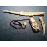 A carved ivory crocodile; a carved tooth like piece with figural decoration; and an inro type box in