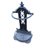 A Victorian cast iron stickstand of D-shaped outline, with ribbed rail above drip tray, the back