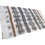 A South American kelim woven with aztec striped panels on fawn ground, the ends with mocha bands -