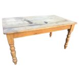 A 5ft rectangular pine kitchen table, with top dowel jointed on plain rails, raised on turned