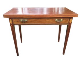 A nineteenth century mahogany turn-over-top tea table, the twin rectangular top inlaid with