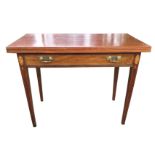 A nineteenth century mahogany turn-over-top tea table, the twin rectangular top inlaid with