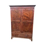A nineteenth century mahogany wardrobe with moulded greek key cornice above a frieze with arched