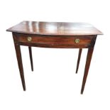 A bowfronted nineteenth century mahogany side table with moulded top above a long frieze drawer
