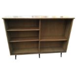 An oak open bookcase with adjustable shelves raised on six ebonised tapering legs with brass