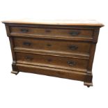 A European oak chest of three graduated panelled drawers mounted with brass handles framed by