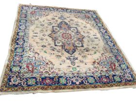 An Axminster wool carpet woven in the eastern Persian manner with central floral medallion on fawn