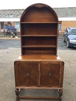 A C20th oak dresser with arched bead moulded back having shell carved apron above three plate
