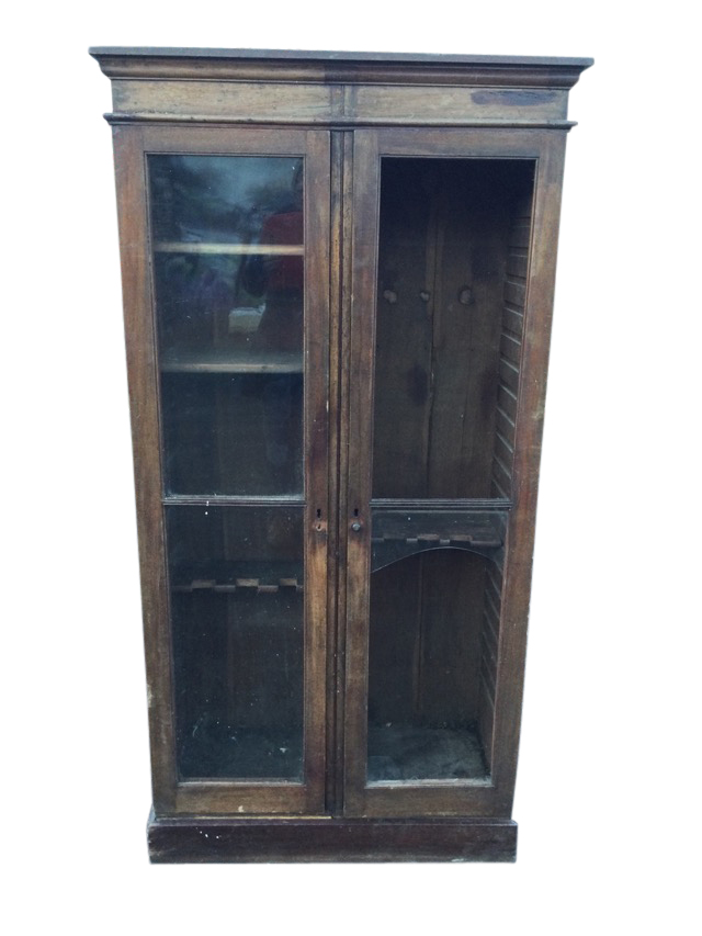 A nineteenth century glazed mahogany cupboard with moulded cornice above two doors enclosing