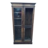 A nineteenth century glazed mahogany cupboard with moulded cornice above two doors enclosing