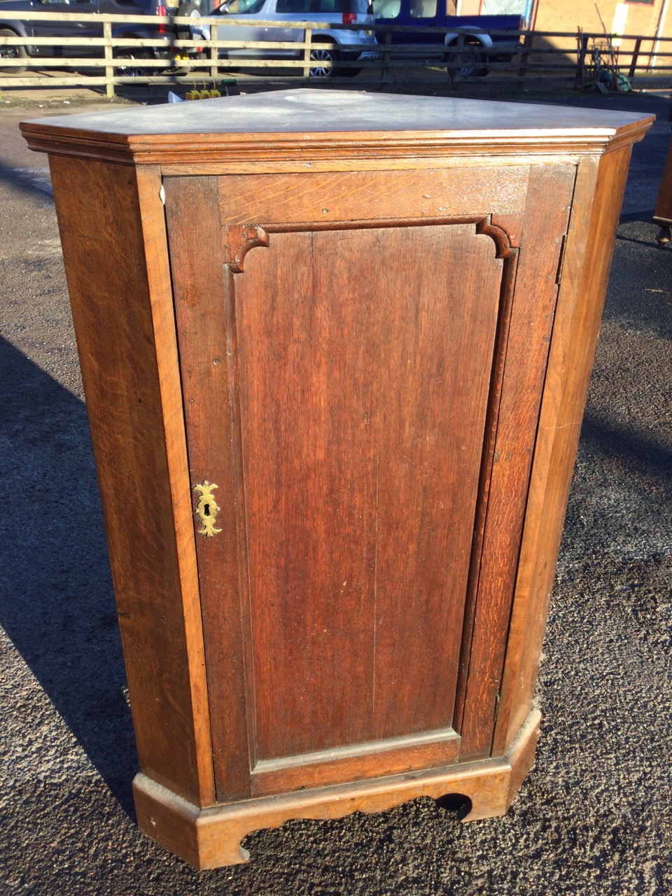 A nineteenth century oak corner cabinet with panelled door enclosing shaped shelves, raised on a - Image 3 of 3