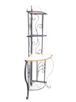 A wrought iron corner shelf unit with scrolled back, having two grill shelves above a wood platform,